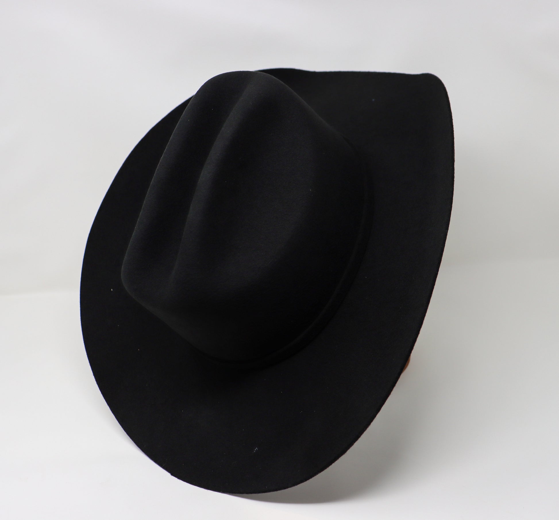 Black fedora hat on a white background